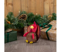 Ancol Mini Tina Turkey dog toy with a smooth brown body, red head and wattle, yellow beak and small yellow feet, beside wrapped Christmas presents.