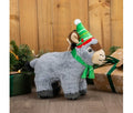 Ancol Dominic the Donkey grey plush dog toy with dark hooves, a green scarf and green Christmas hat, standing beside wrapped presents.