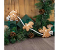 Ancol Gingerbread Rope dog toy with a brown gingerbread house, person and angel attached along a white rope, pictured among Christmas presents.