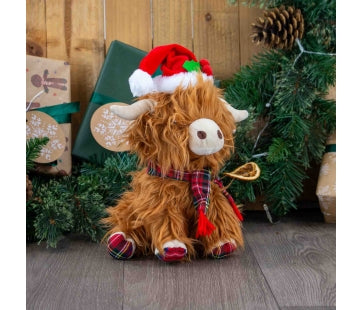 Ancol Festive Fergus Highland Cow shaggy brown plush dog toy wearing a red-and-white Christmas hat and tartan scarf, with pale horns and tartan feet.